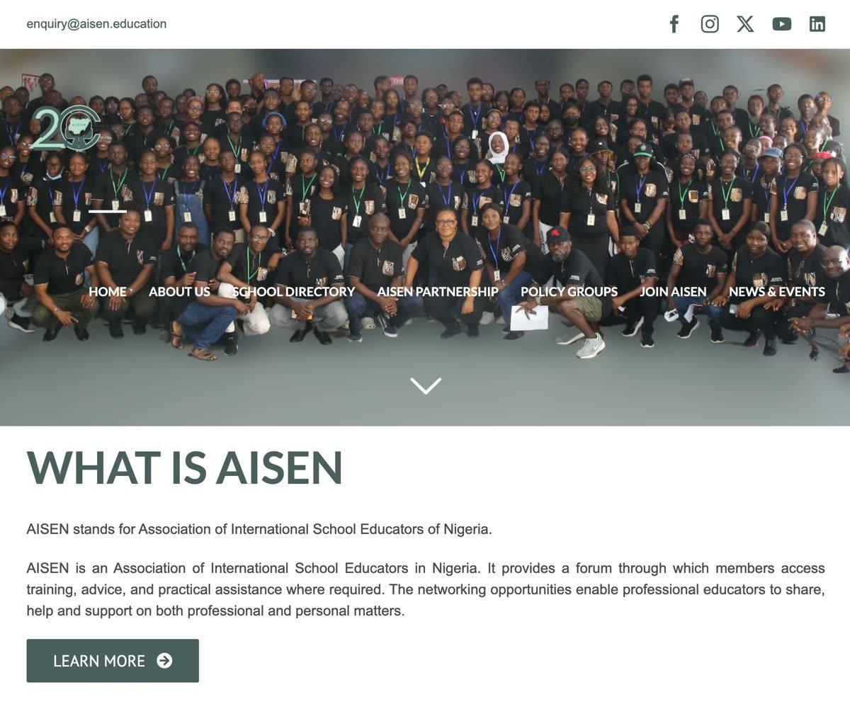AISEN home page: a large group photo of educators and students under the heading What is AISEN